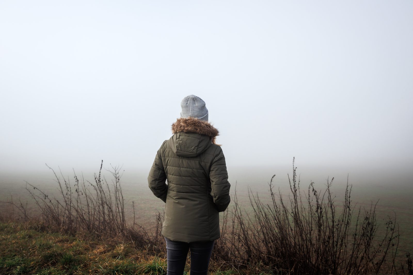 Lost person in fog. Lonely woman in empty misty landscape