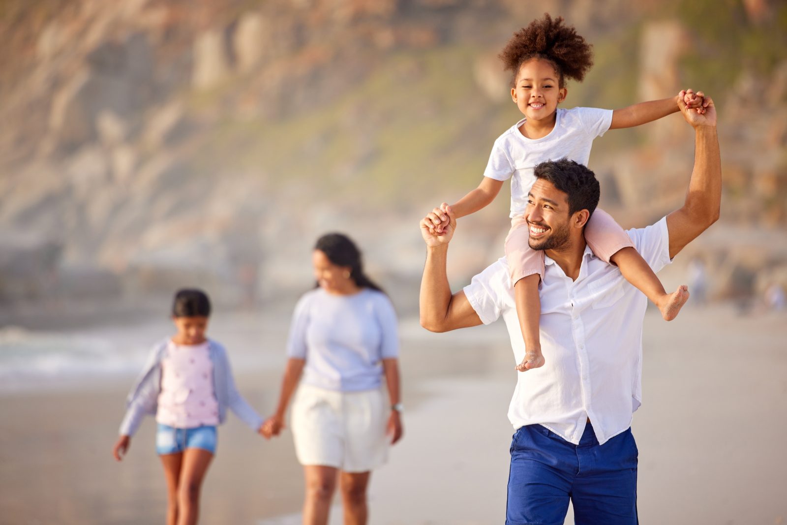 Shot of a beautiful young family of three spending the day together at the beach.