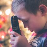 boy holding Holy Bible